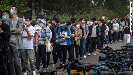 Mensen staan ​​maandag in de rij voor Covid-tests op een tijdelijke testlocatie in het Chaoyang-district in Peking.