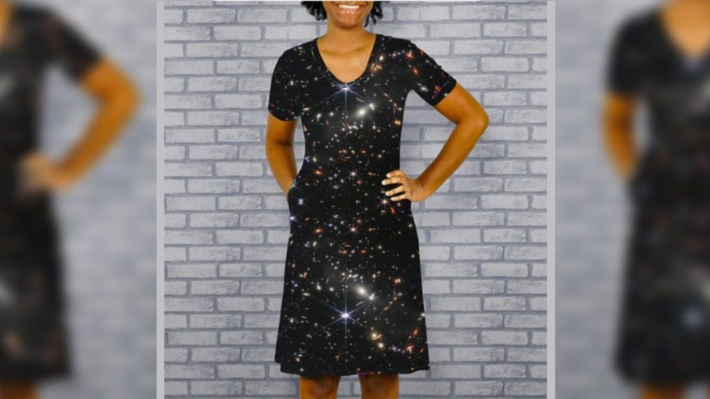 Woman wearing a dress with a design depicting a james web space telescope photograph