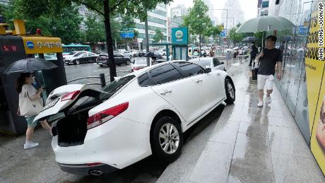 Een voertuig liep schade op op het trottoir nadat het op 9 augustus in Seoel, Zuid-Korea, verpletterd was door hevige regen.